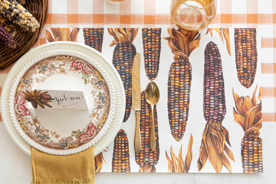 The Gathering Maize Placemat under a fall-themed place setting, from above.