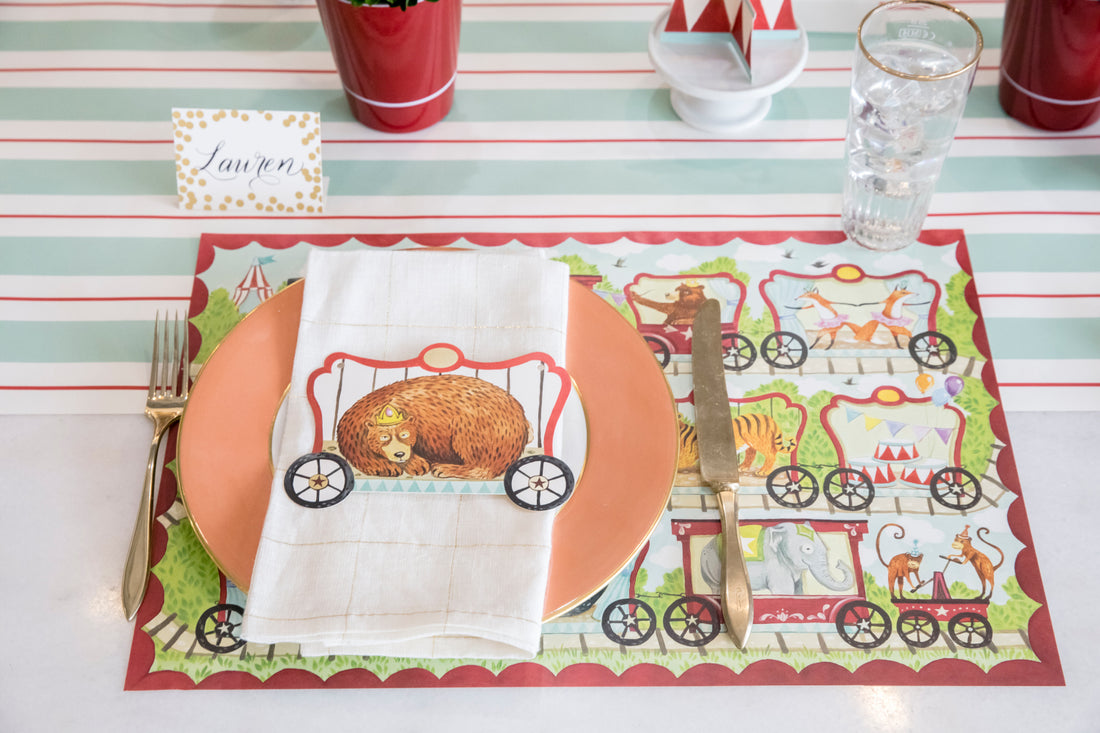 A whimsical place setting featuring a Gold Foil Confetti Place Card labeled &quot;Lauren&quot; standing behind the plate.