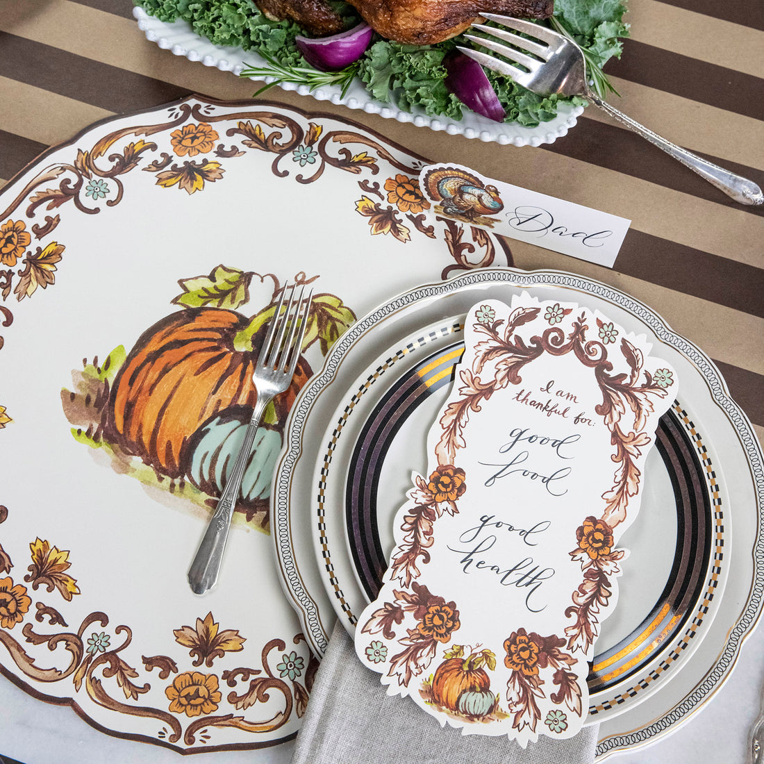 An elegant Thanksgiving place setting featuring an &quot;I Am Thankful For&quot; Table Accent resting on the plate.