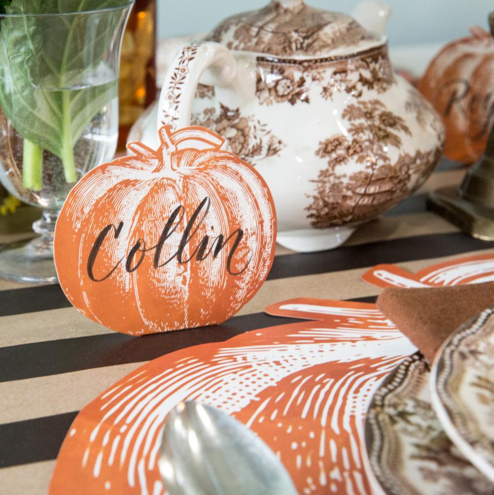 An elegant fall table setting featuring a Pumpkin Place Card labeled "Collin" standing behind a plate.