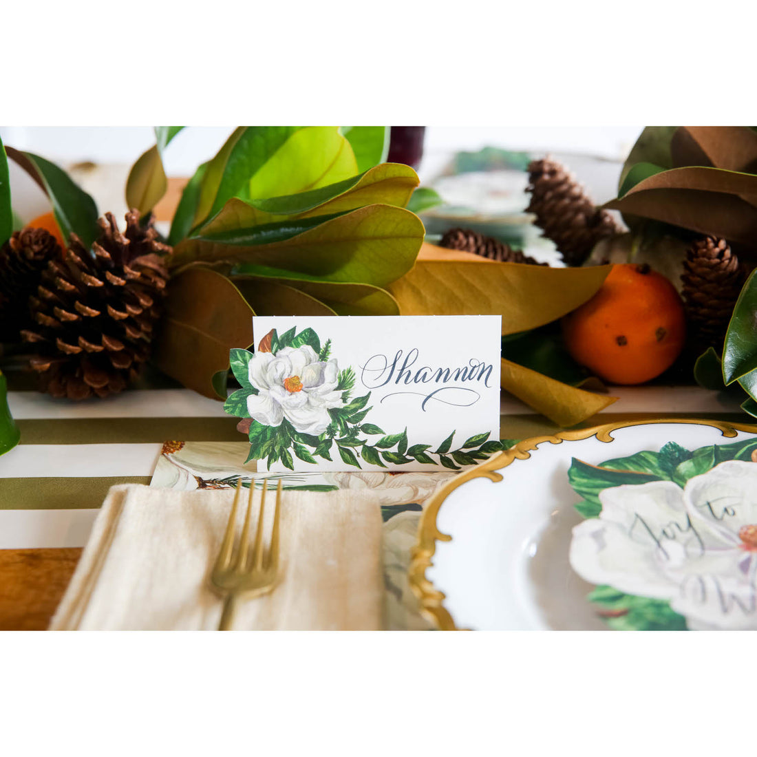 An elegant place setting featuring a Magnolia Place Card labeled &quot;Shannon&quot;.