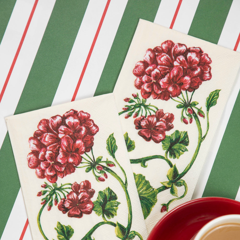 The Green & Red Awning Stripe Runner under a Christmas-themed place setting with a cup of coffee.
