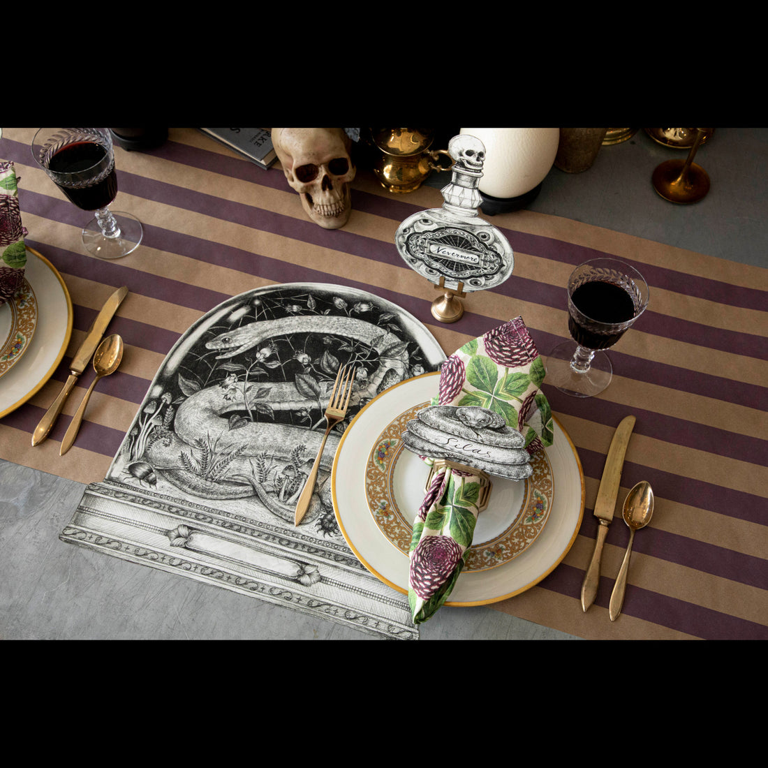 The Die-cut Snake Cloche Placemat under a spooky Halloween-themed place setting.