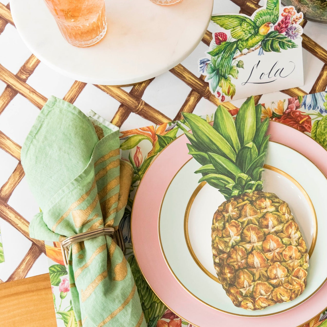 A vibrant tropical place setting featuring a Pineapple Table Accent resting on the plate.