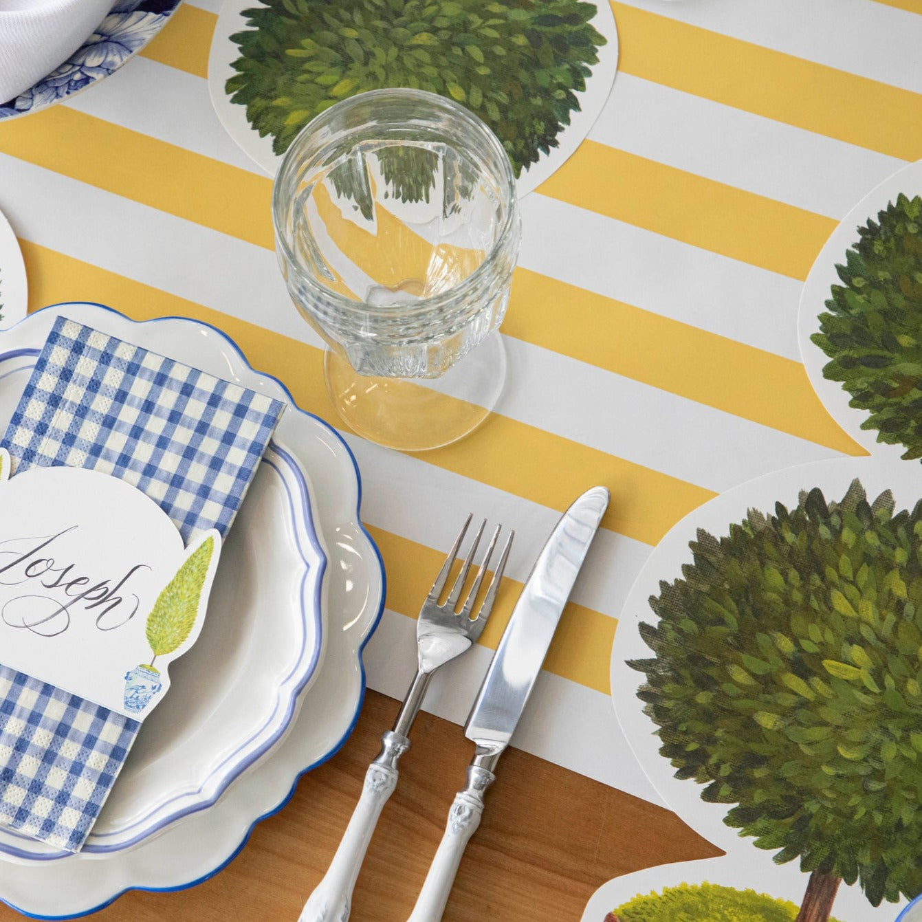 A Marigold Classic Stripe Runner from Hester & Cook under an elegant place setting.