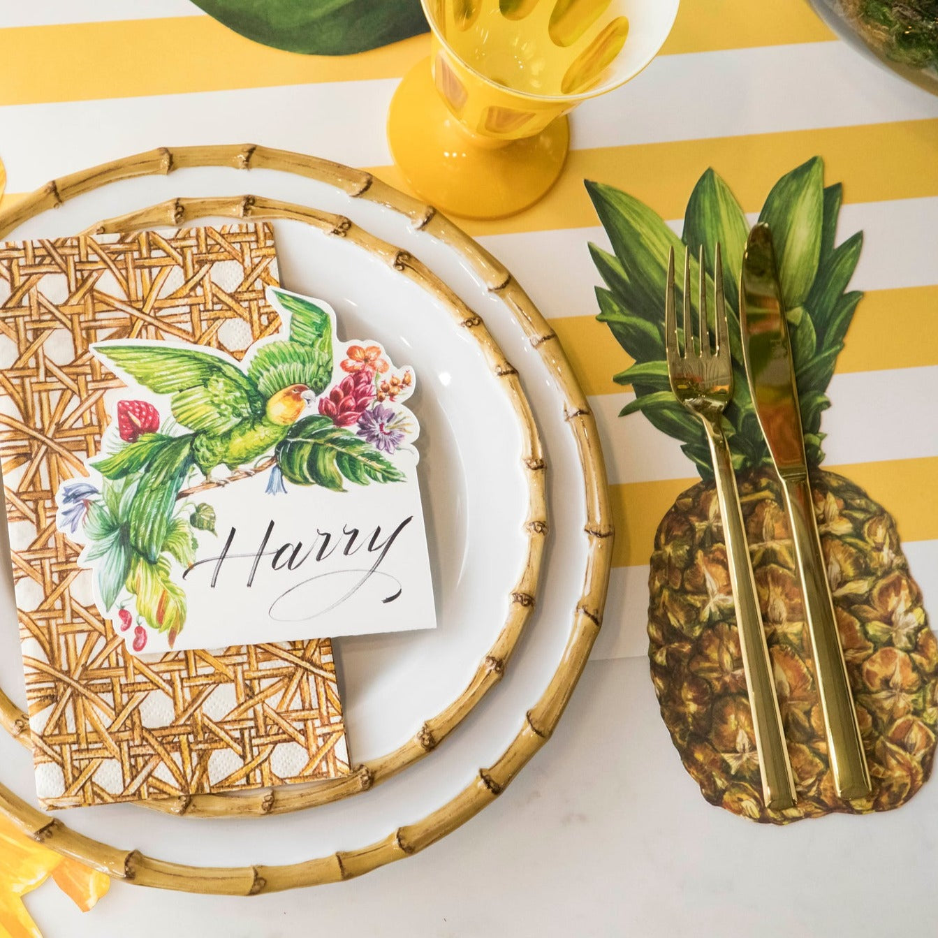A vibrant tropical place setting featuring a Pineapple Table Accent under the cutlery.