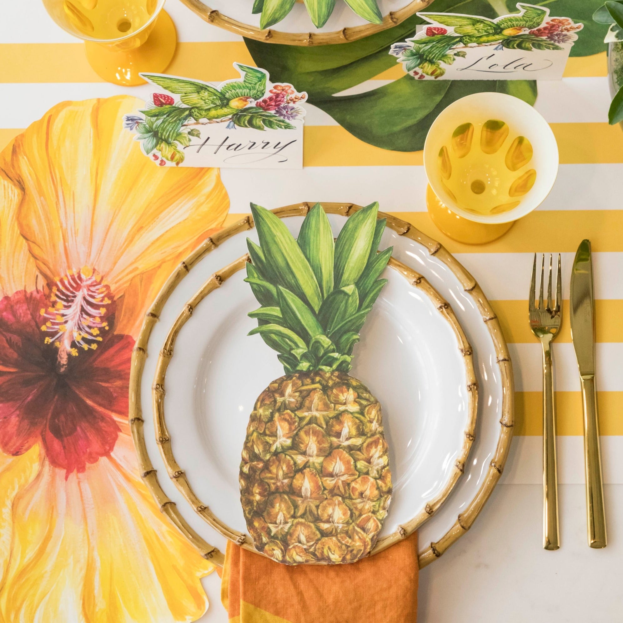 Top-down view of a vibrant tropical-themed place setting featuring a Parrot Place Card standing behind the plate.