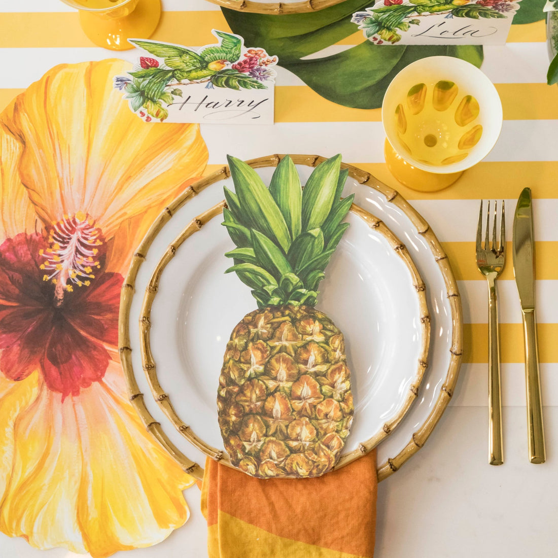 Top-down view of a vibrant tropical place setting featuring a Pineapple Table Accent resting on the plate.