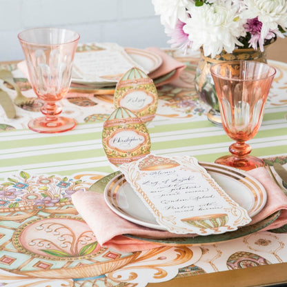 An elegant Easter table setting featuring Exquisite Egg Place Cards standing behind each plate.