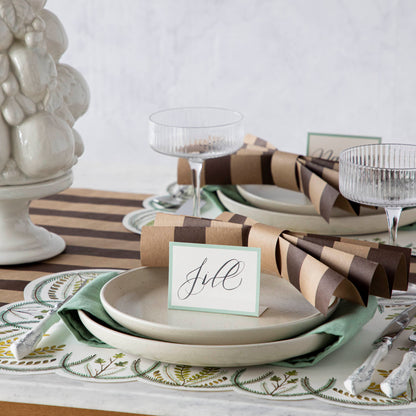 The Kraft Brown Classic Stripe Runner under an elegant table setting, plates adorned with crafted bows made from cut pieces of the runner.