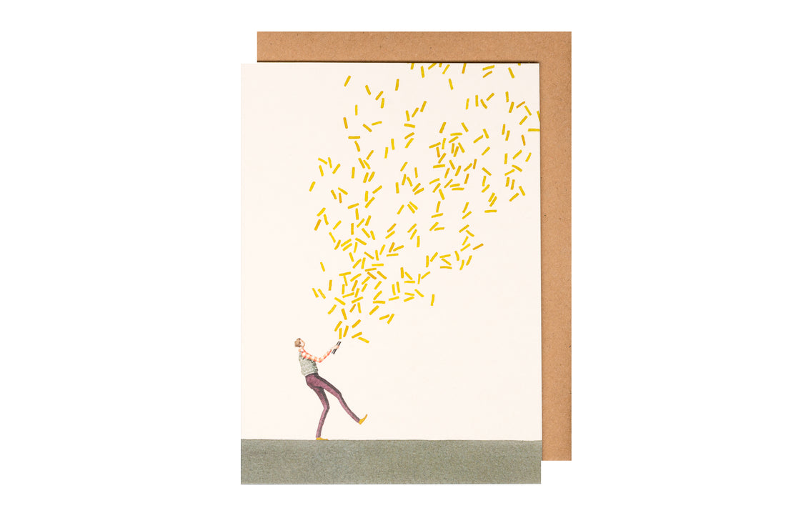 A person catches a shower of yellow objects on an environmentally sustainable paper greetings card designed by Hester &amp; Cook.