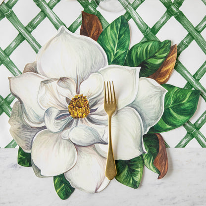 The Green Lattice Placemat paired with a Magnolia Die-Cut Placemat under an elegant place setting.