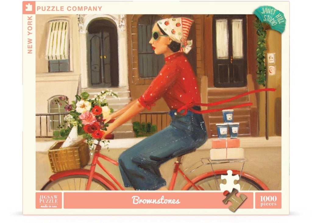 A Brownstones Puzzle of a woman riding a red bicycle with a basket of flowers in front of a building with windows and doors, crafted by Janet Hill, by New York Puzzle Company.