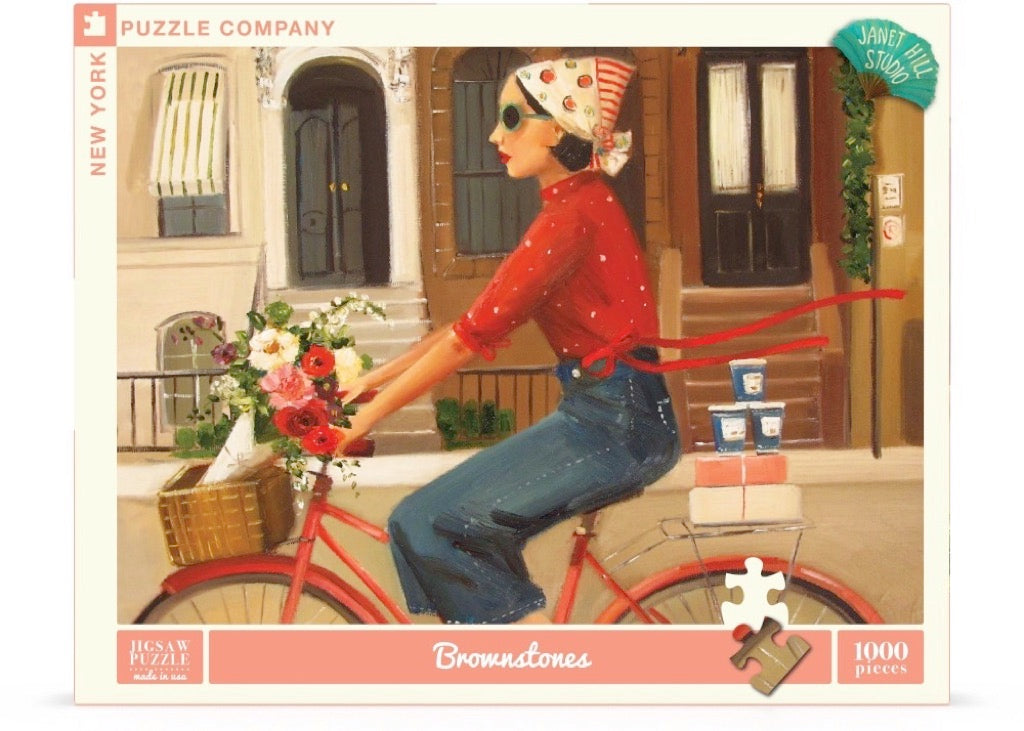 A Brownstones Puzzle of a woman riding a red bicycle with a basket of flowers in front of a building with windows and doors, crafted by Janet Hill, by New York Puzzle Company.