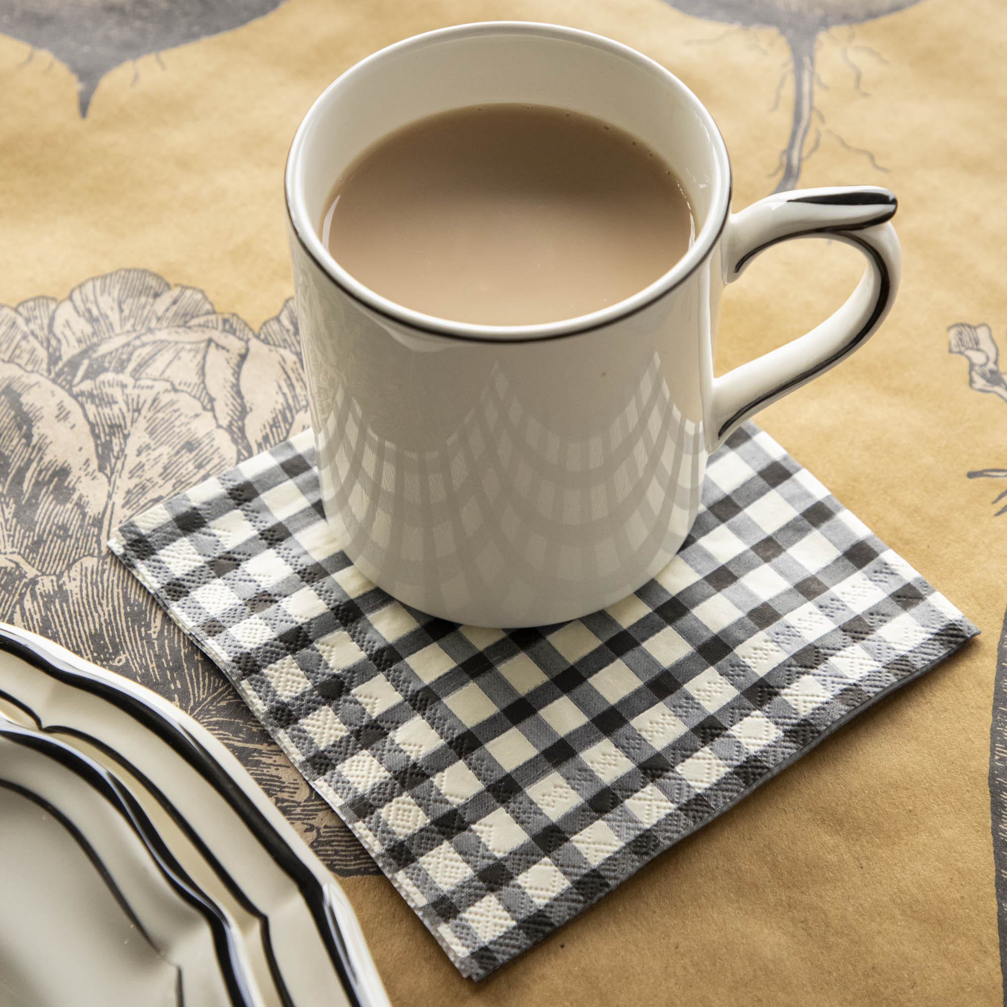 An elegant fall table setting with a Black Painted Cocktail Napkin under a coffee cup.