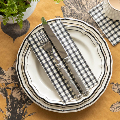 An elegant fall table setting with a Black Painted Guest Napkin on a plate with cutlery on top, and a Black Painted Cocktail Napkin under a coffee cup.
