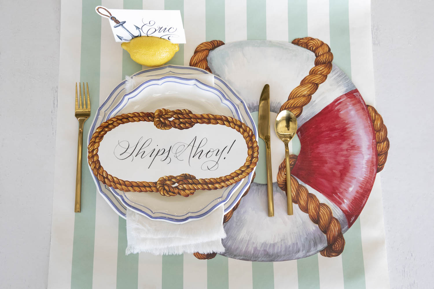 The Die-cut Life Preserver Placemat under an elegant nautical-themed place setting, from above.