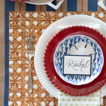 The Rattan Weave Placemat under a nautical-themed place setting, from above.