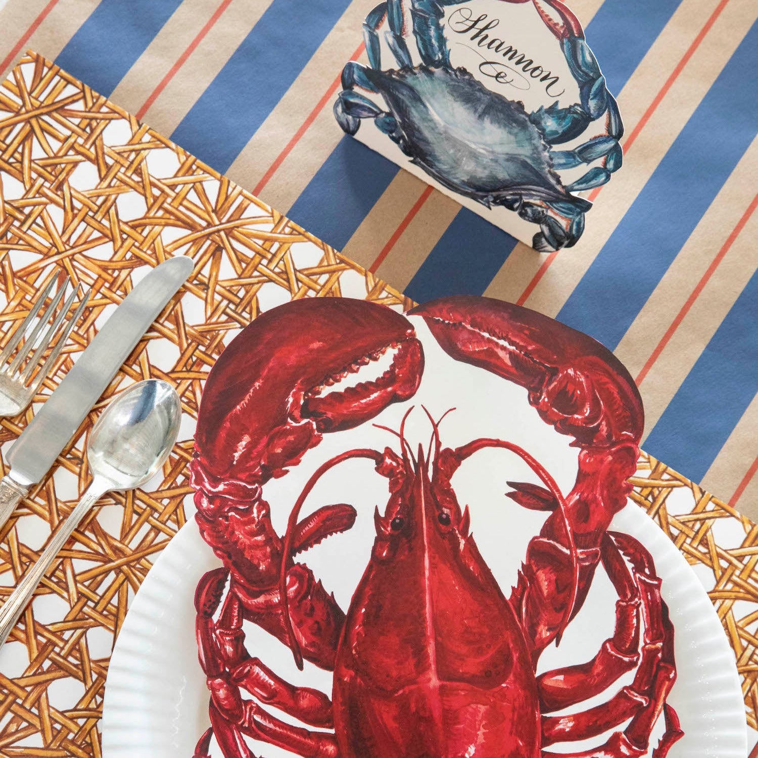 The Kraft Navy & Red Awning Stripe Runner under a nautical-themed place setting, from above.