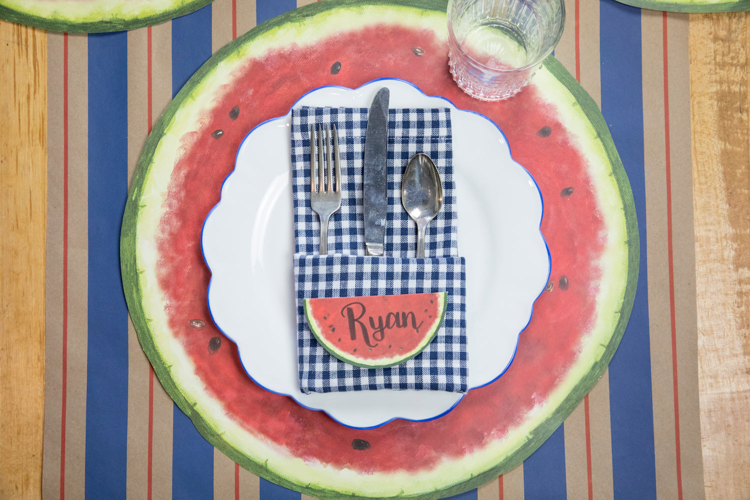 The Kraft Navy &amp; Red Awning Stripe Runner under a summertime place setting, from above.