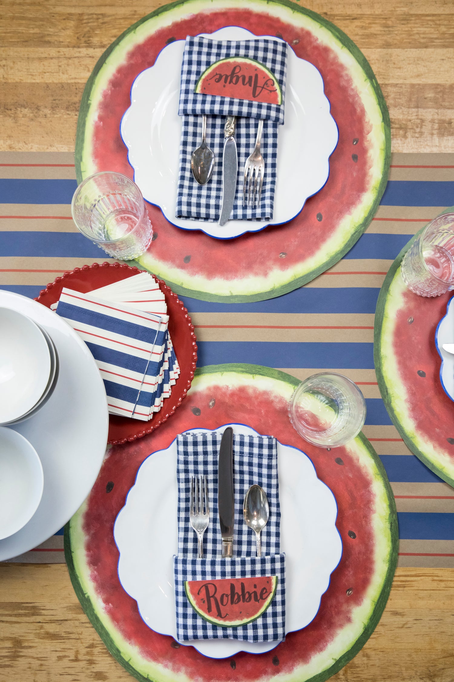 The Kraft Navy &amp; Red Awning Stripe Runner under a summertime table setting, from above.