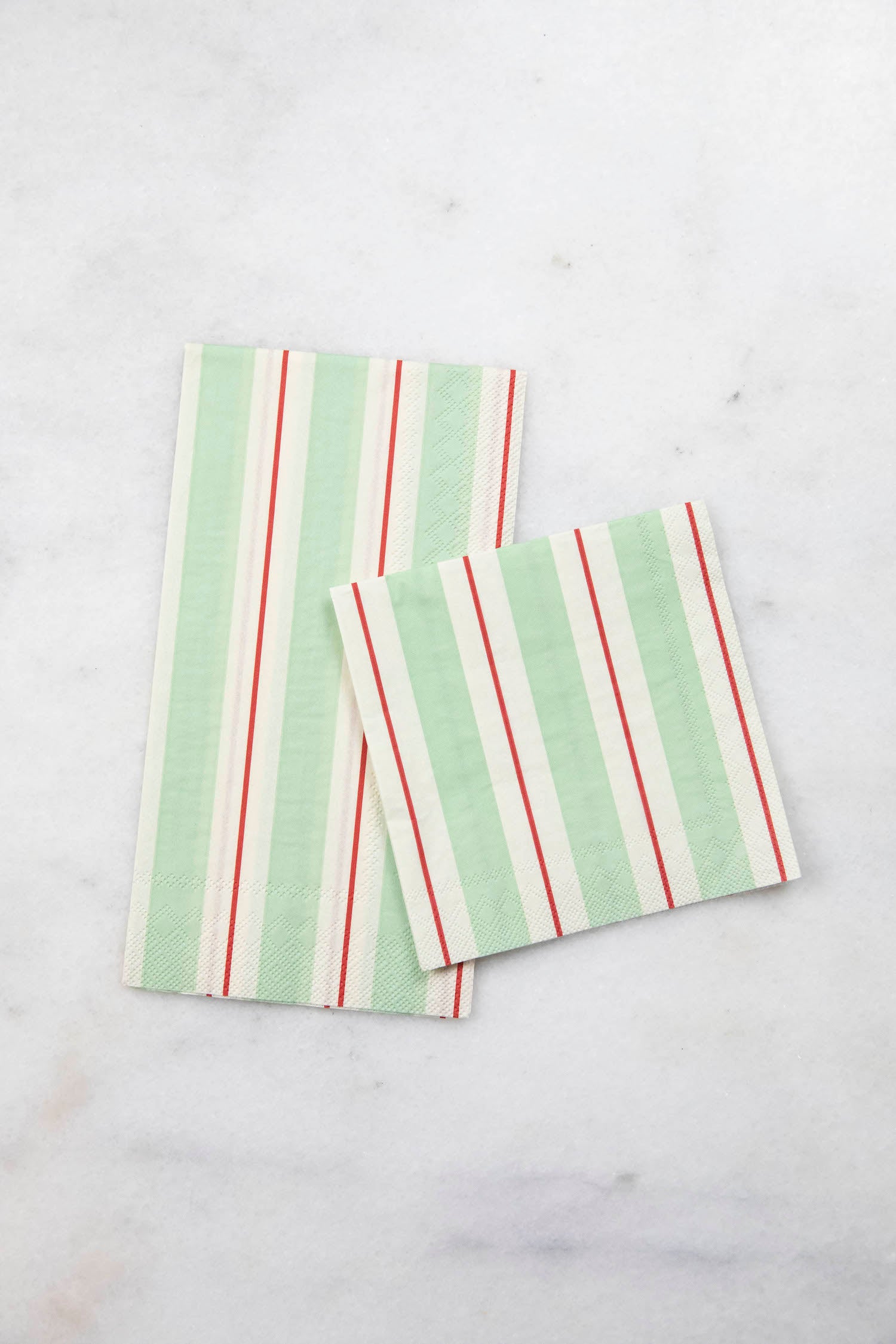 Two Seafoam &amp; Red Awning Stripe Napkins, one Guest and one Cocktail, by Hester &amp; Cook on a table.