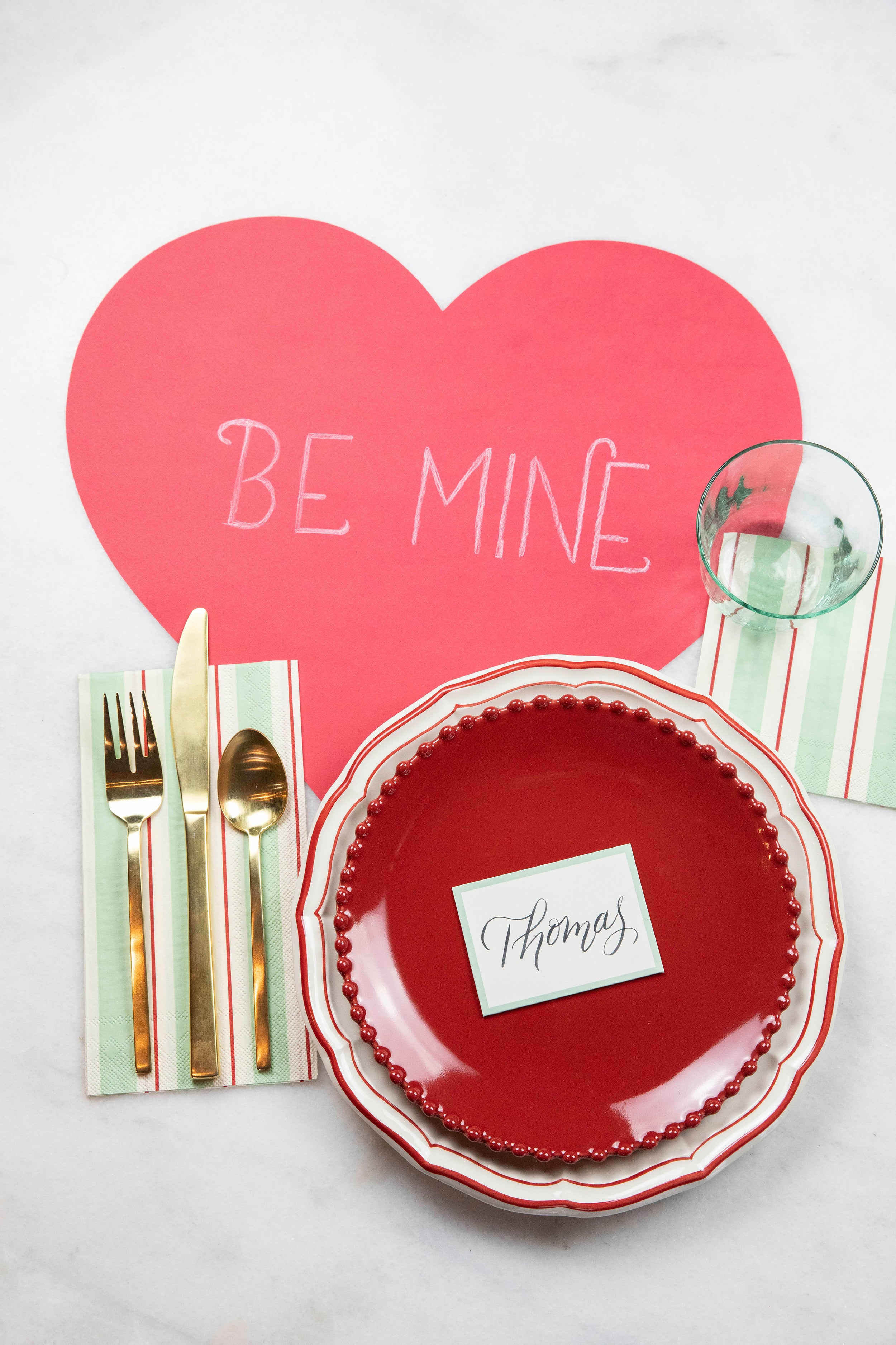 The Die-cut Red Heart Placemat with &quot;BE MINE&quot; hand-written on it in white chalk, under a Valentine&