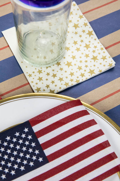 A Shining Star Cocktail Napkin under the water glass of a patriotic place setting.