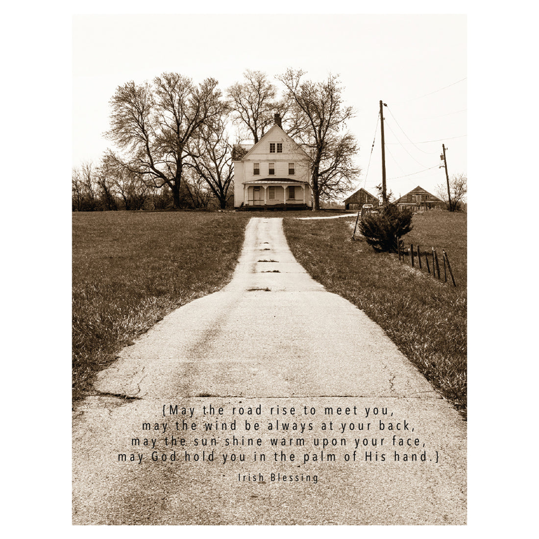 A sepia-tone photo of a long paved path leading to a white house in the distance, with an Irish blessing printed in black along the bottom of the card.