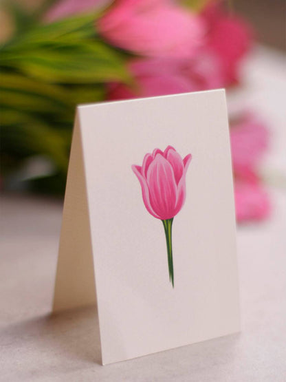 Colorful Fresh Cut Paper Tulip Pop Up Flower Bouquets arranged in vases on a white table.