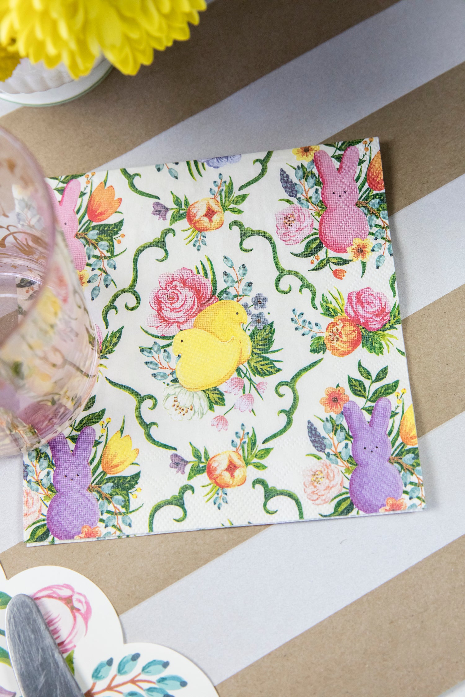 Close-up of a PEEPS® Cocktail Napkin under the water glass of an elegant Easter place setting.