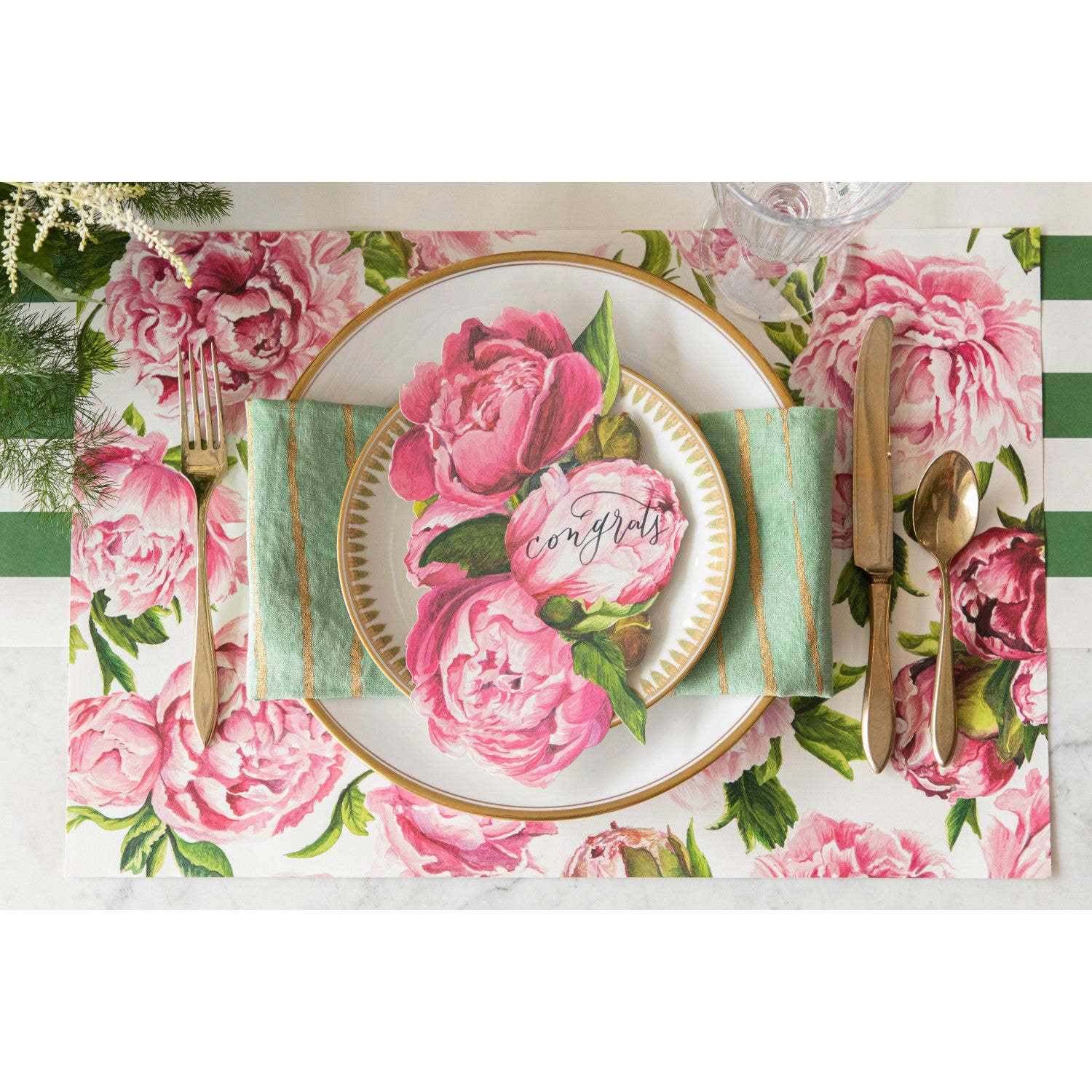 The Peonies In Bloom Placemat under an elegant place setting, from above.
