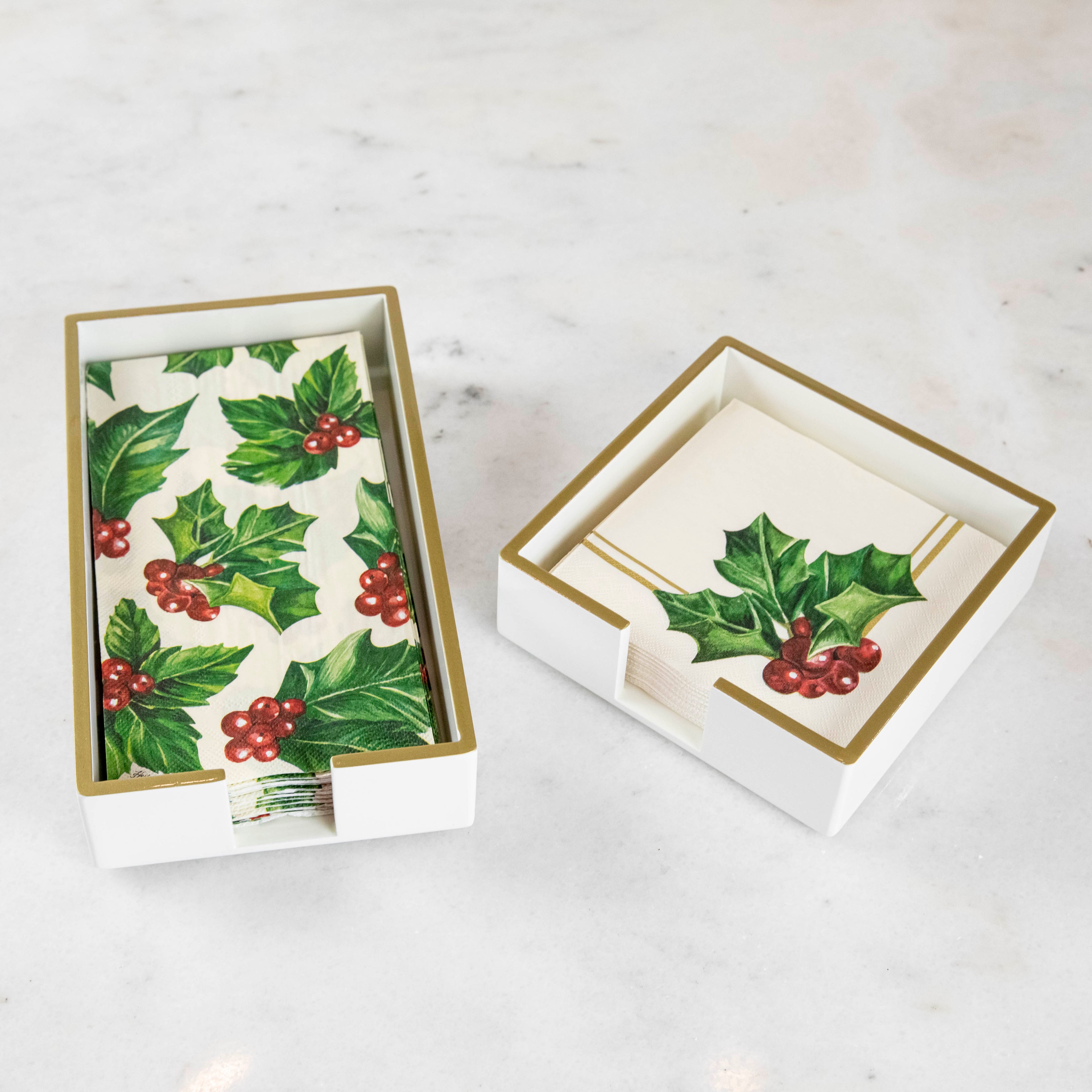 White lacquered guest and cocktail napkin holders with napkins inside.