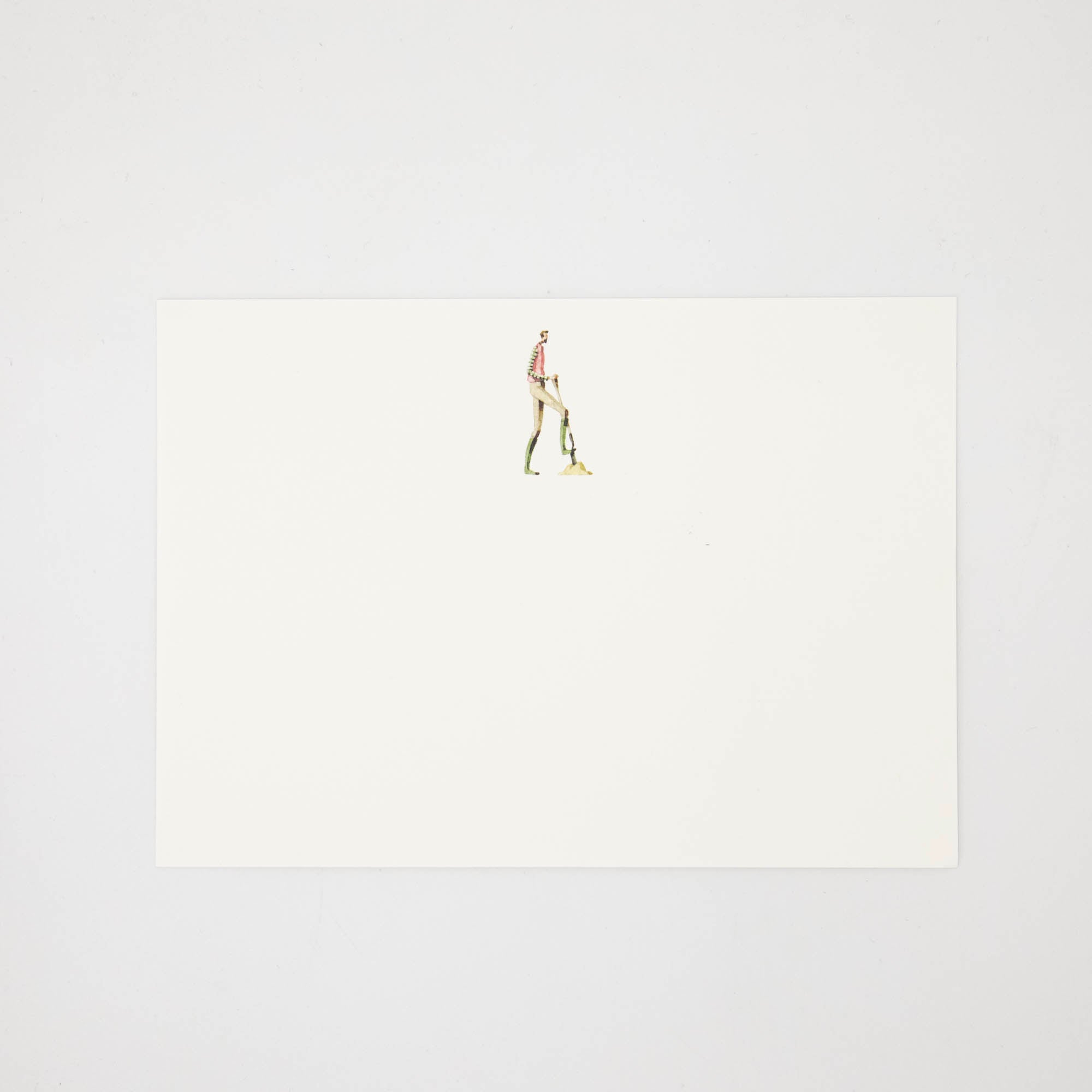 The other side of the note card features an illustration of a man digging with a shovel centered at the top of the card.