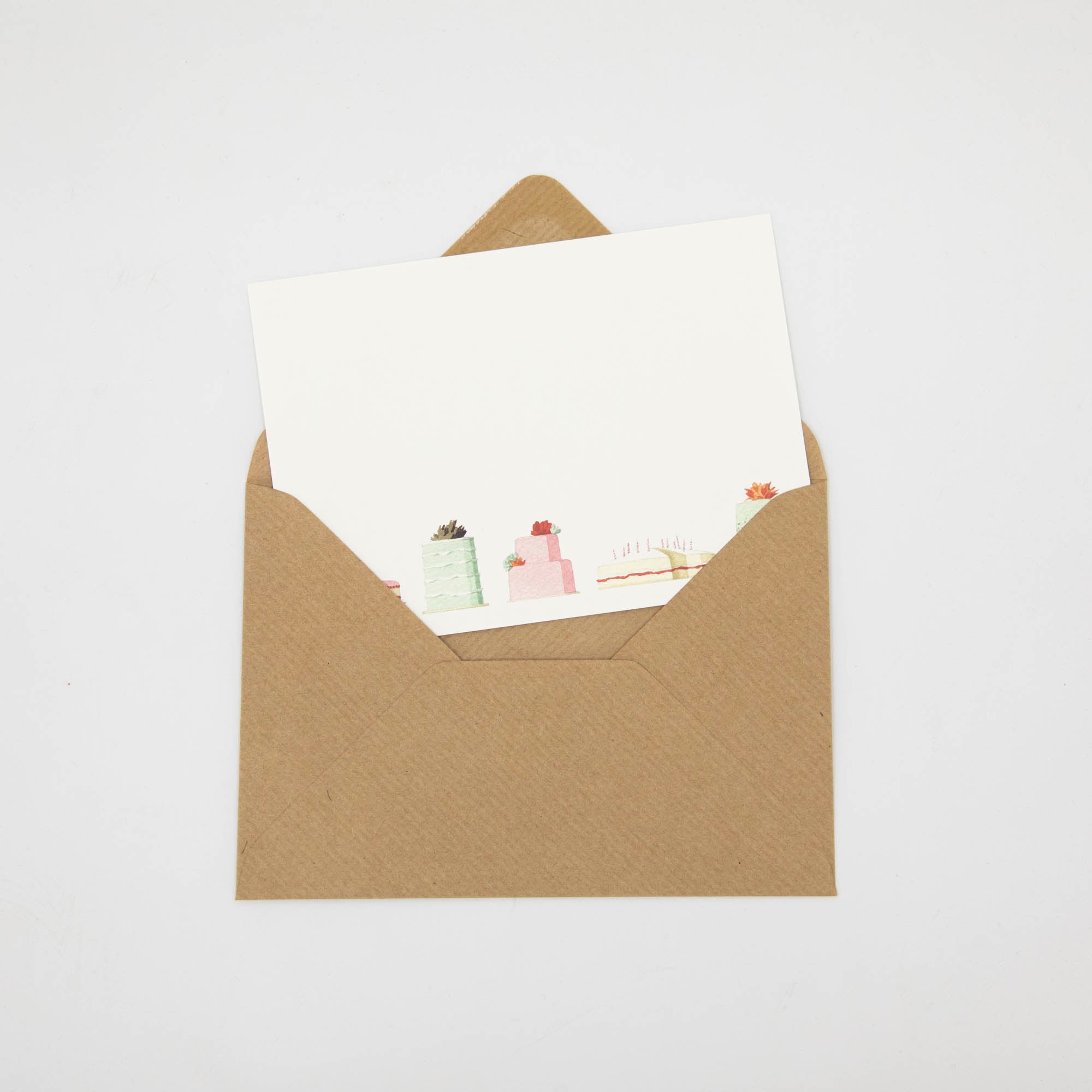 A Cakes Flat Note with a kraft paper envelope, included.
