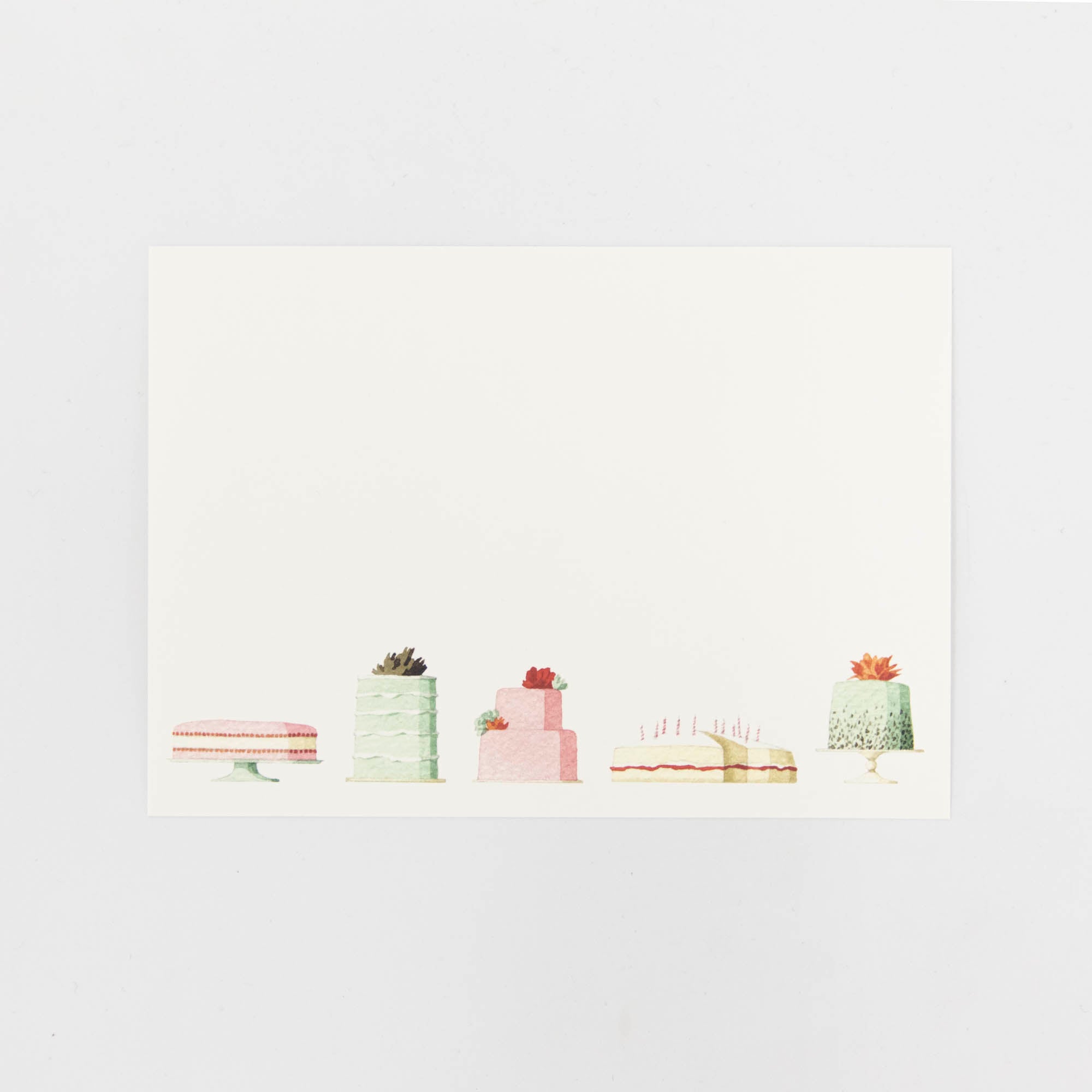 A Cakes Flat Notes card featuring an illustrated row of decadent cakes along the bottom of the white card.