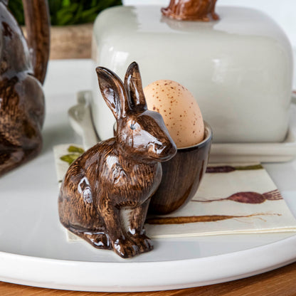 A hand-painted tray with two rabbits and an egg on it by British brand Hare Ceramics.