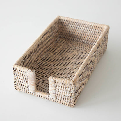 A two Rattan Napkin Holders from Napa Home &amp; Garden on a marble surface.