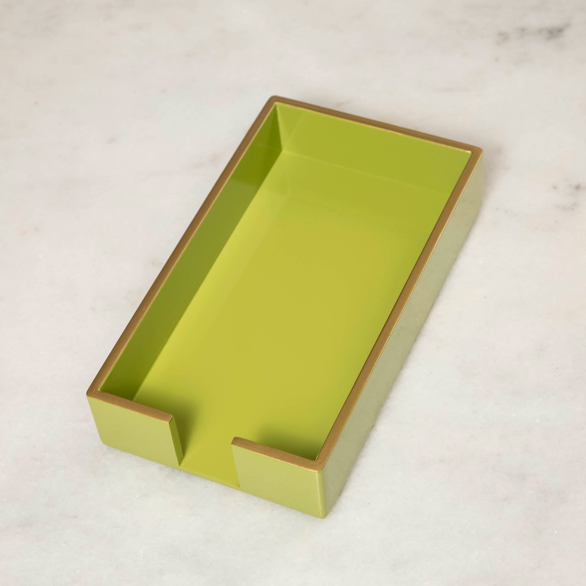 A green lacquered wood beverage and guest napkin caddy with gold trim.