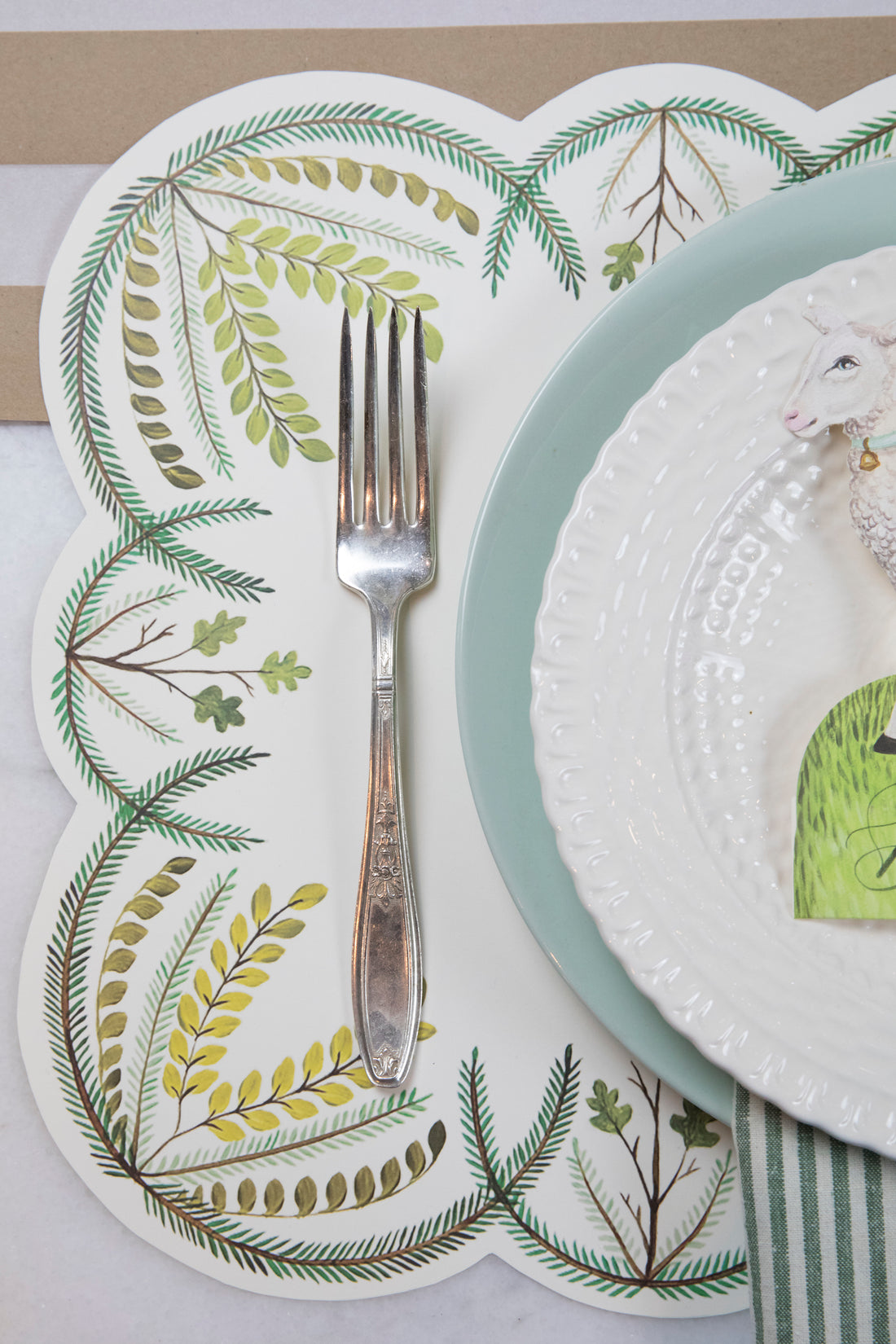 Close-up of the Die-cut Scalloped Seedling Placemat under an elegant springtime place setting.