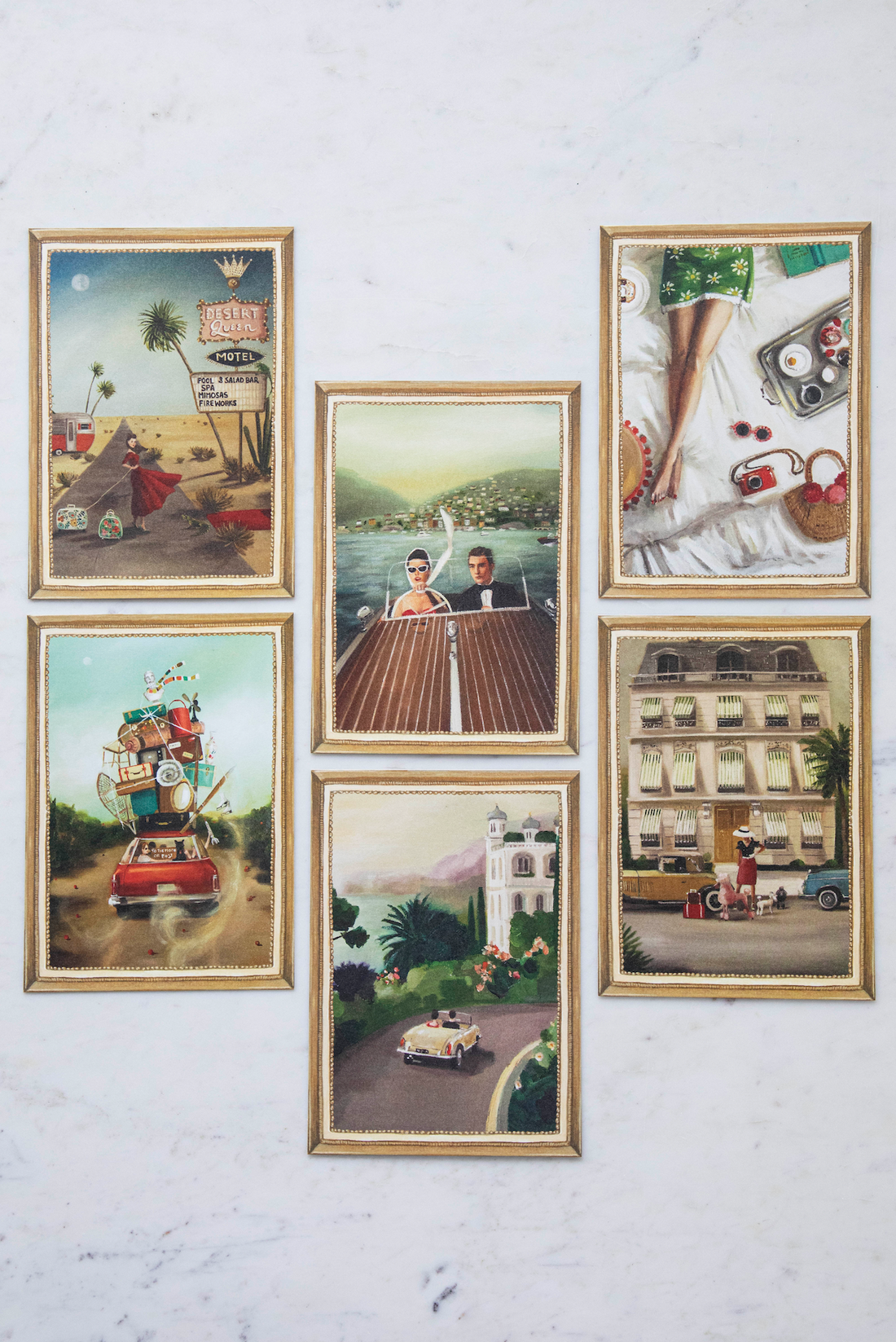 A set of six framed pictures with a Jet Setter Flat Note Boxed Set of 6 Cards from Hester &amp; Cook in the background, embodying travel-inspired artwork.