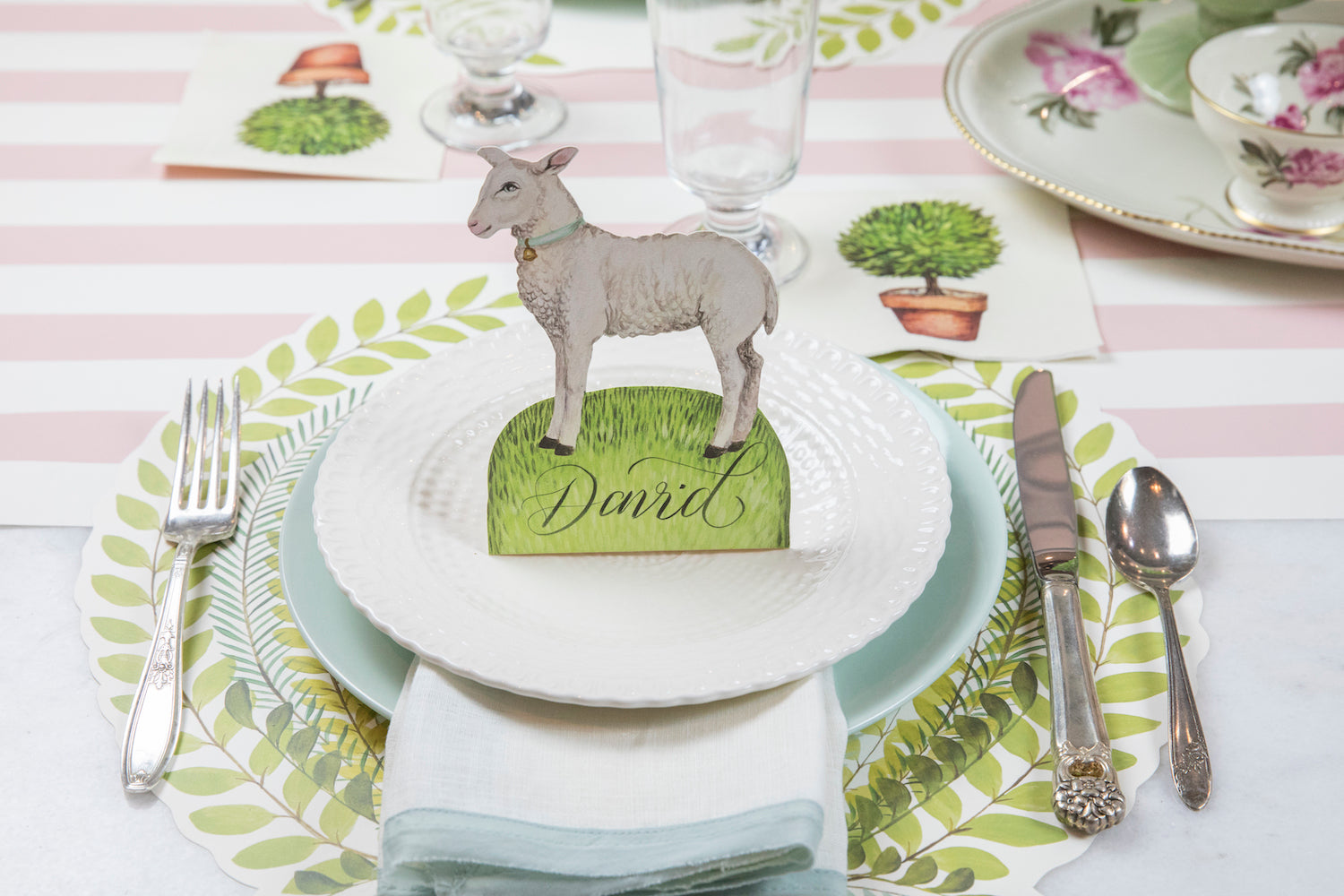 The Die-cut Seedling Wreath Placemat under an elegant place setting.