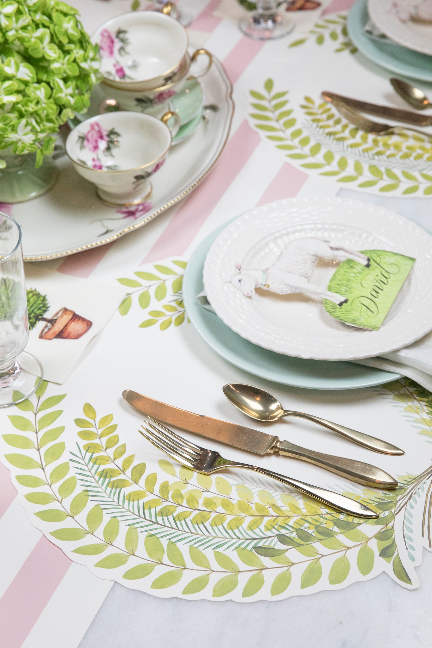 The Die-cut Seedling Wreath Placemat under an elegant springtime table setting, at an angle.