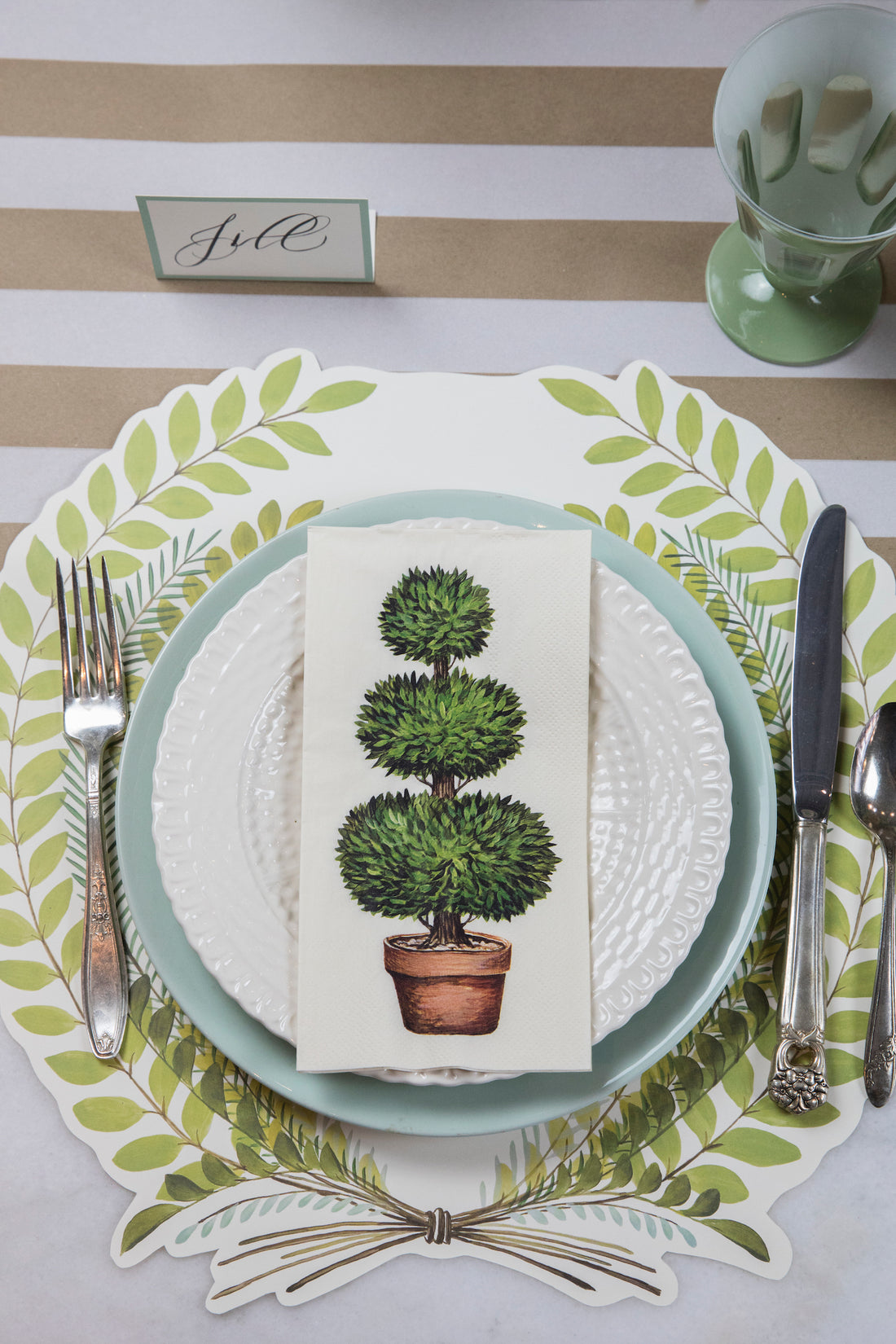 The Die-cut Seedling Wreath Placemat under an elegant place setting, from above.