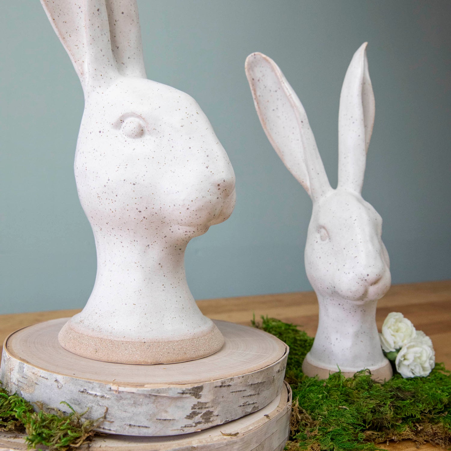 An enchanting HomArt Matte White Ceramic Hares sits on a wood surface.