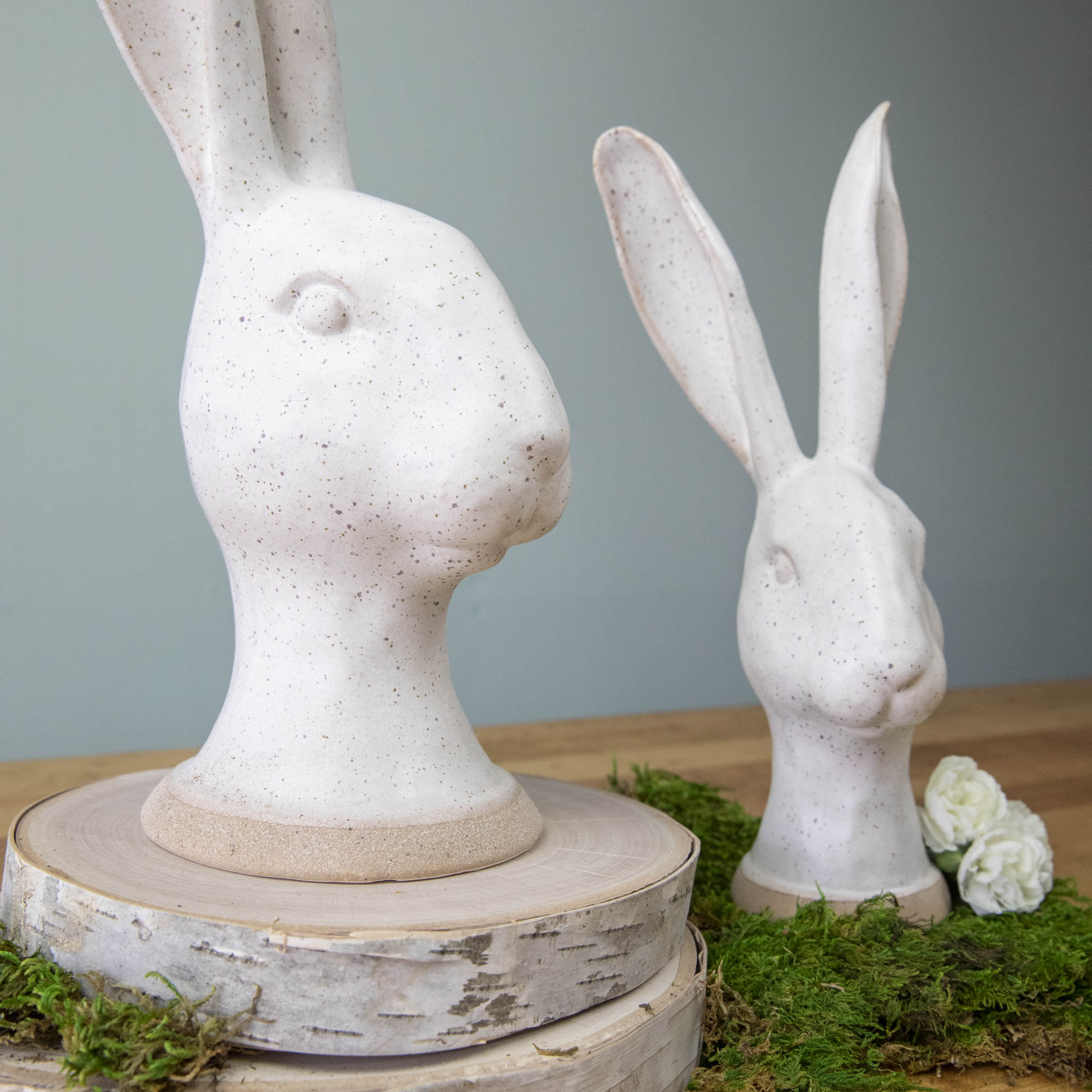 An enchanting HomArt Matte White Ceramic Hares sits on a wood surface.