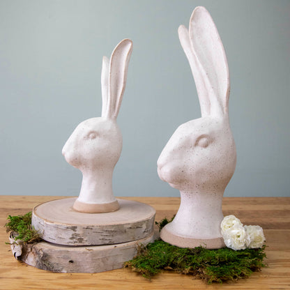 An enchanting HomArt Matte White Ceramic Hares heads on moss, serving as a charming garden decoration.
