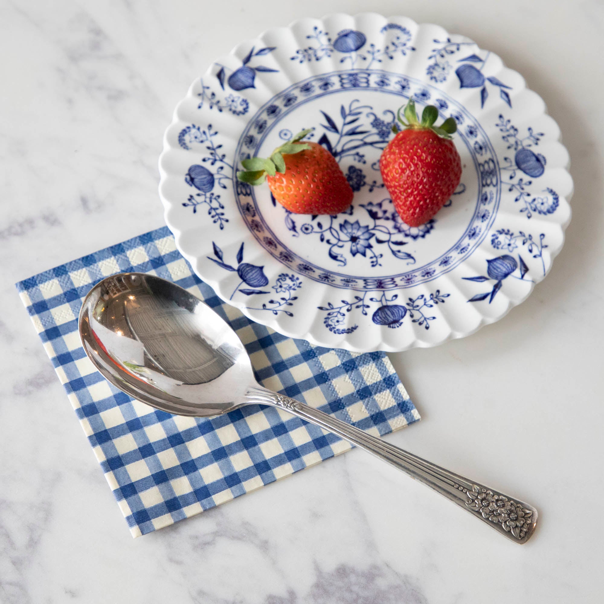 A Hester & Cook vintage silver-plate berry spoon with summer fruits.