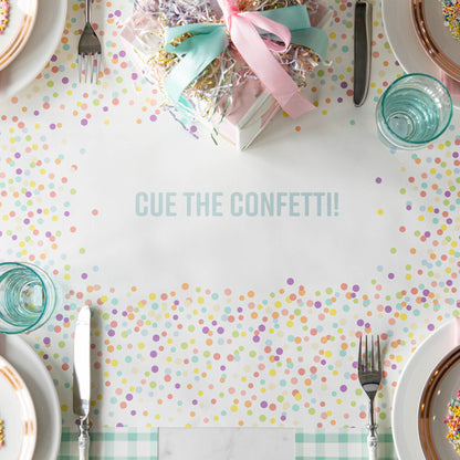 The Confetti Sprinkles Personalized Runner under a birthday table setting, with &quot;CUE THE CONFETTI!&quot; printed in blue, from above.