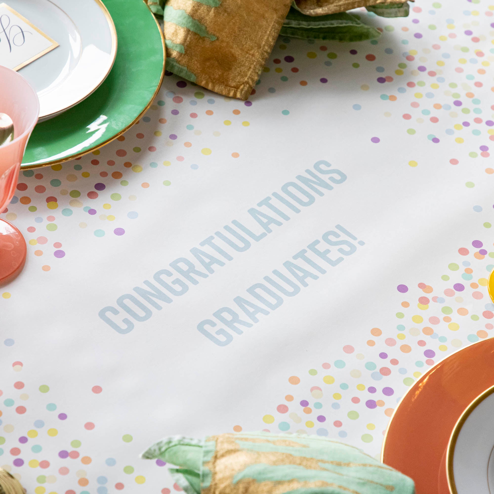 The Confetti Sprinkles Personalized Runner under a festive table setting, with "CONGRATULATIONS GRADUATES!" printed in light blue.